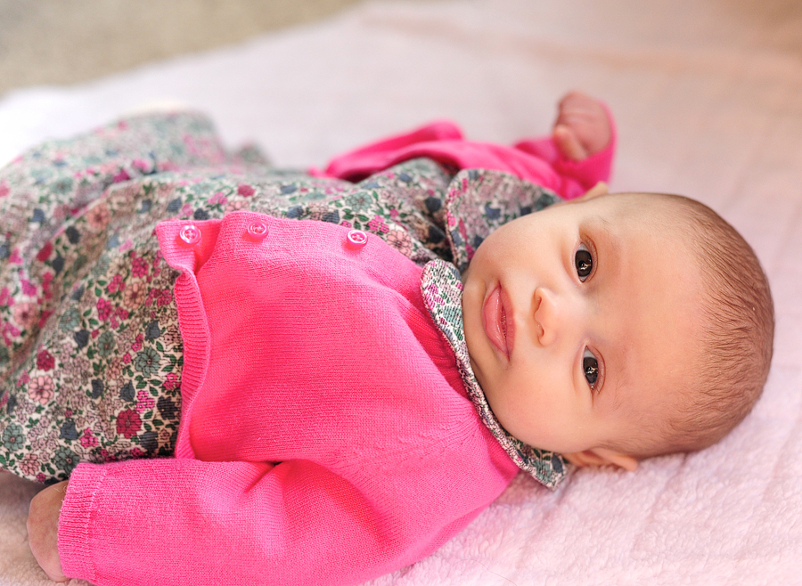 baby in pink cardigan
