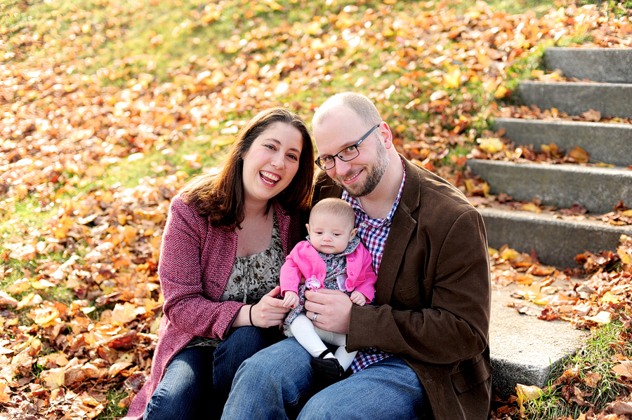 family smiling on steps