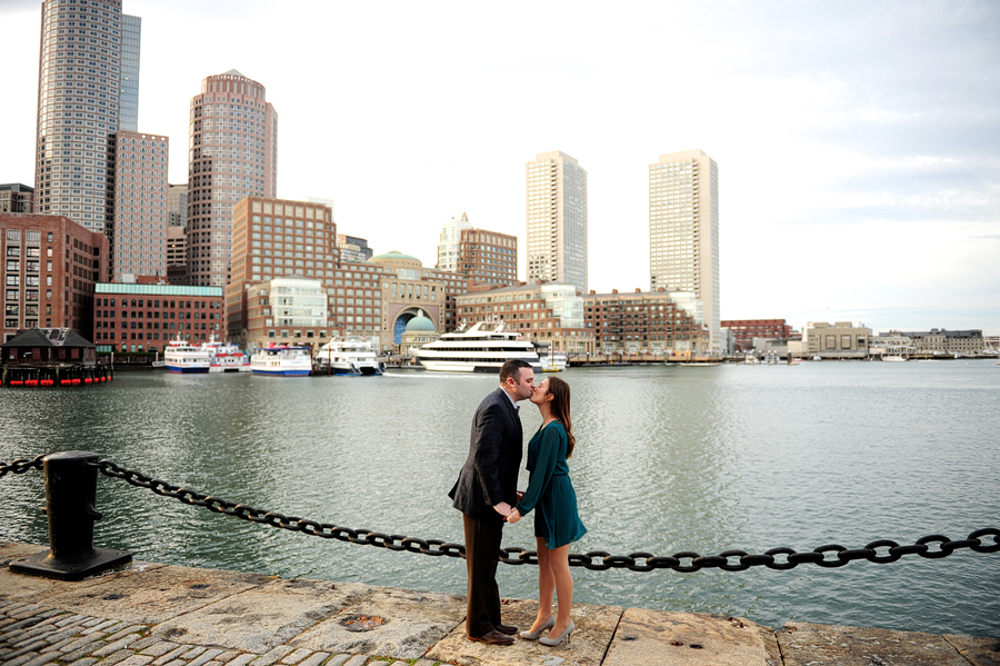 couple kissing during engagement session at boston harborwalk