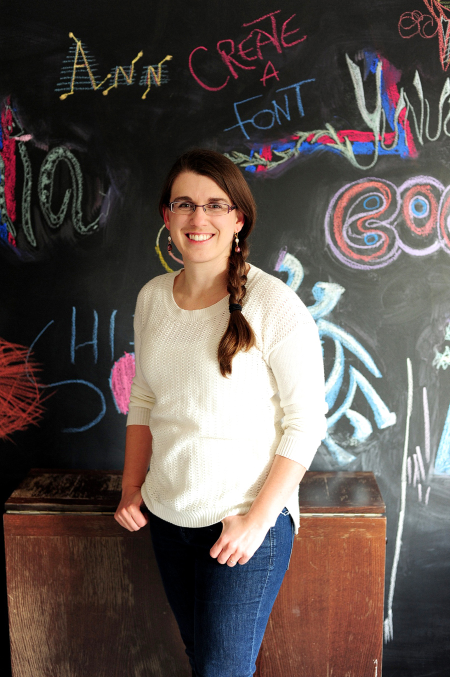 woman in front of chalkboard