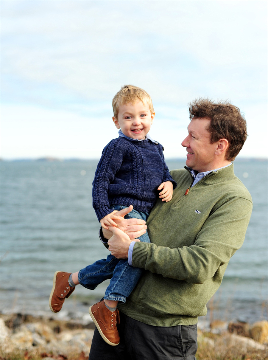 father and son laughing at beach