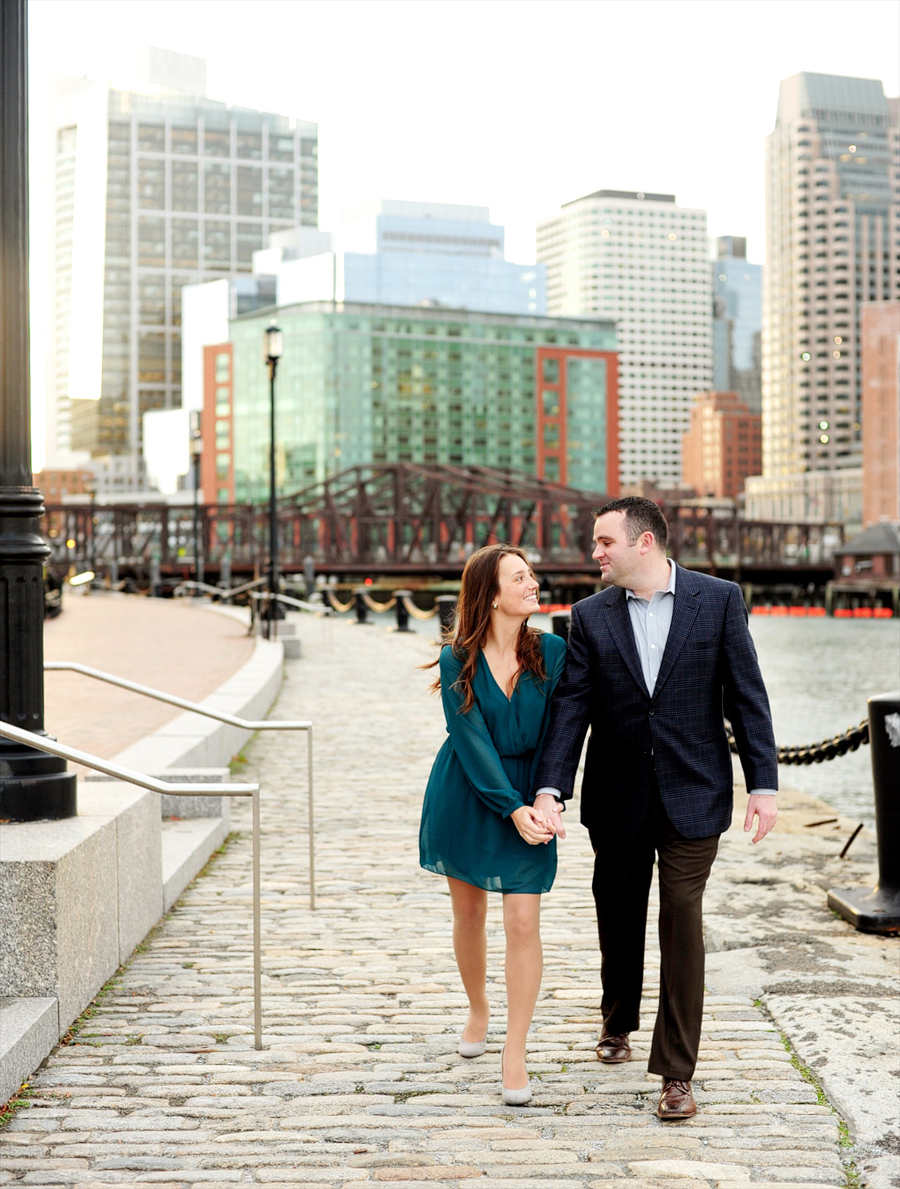 couple walking along boston harborwalk