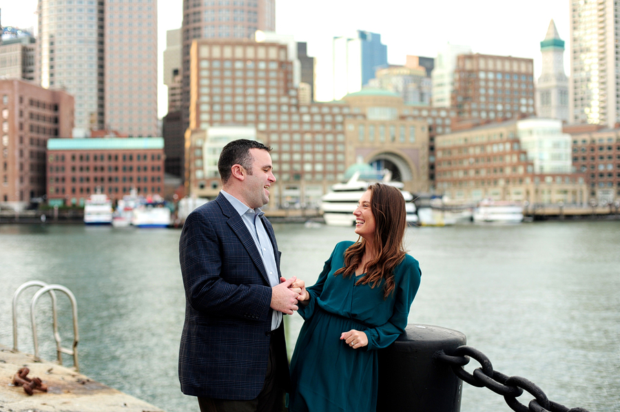 couple laughing in front of boston skyline