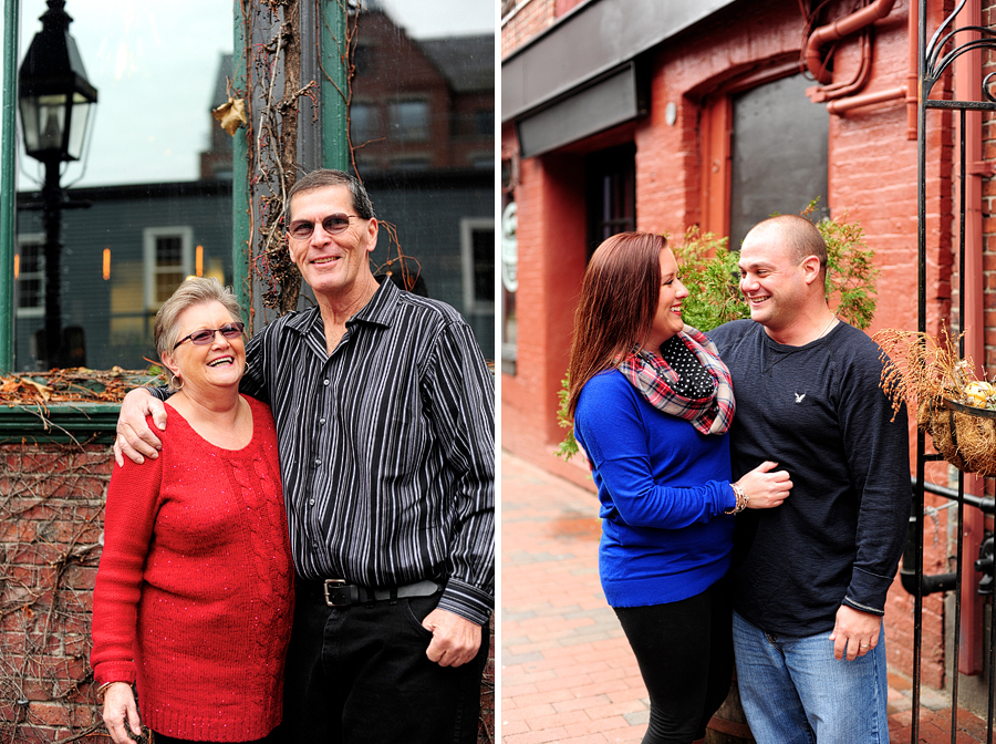 family smiling in front of brick