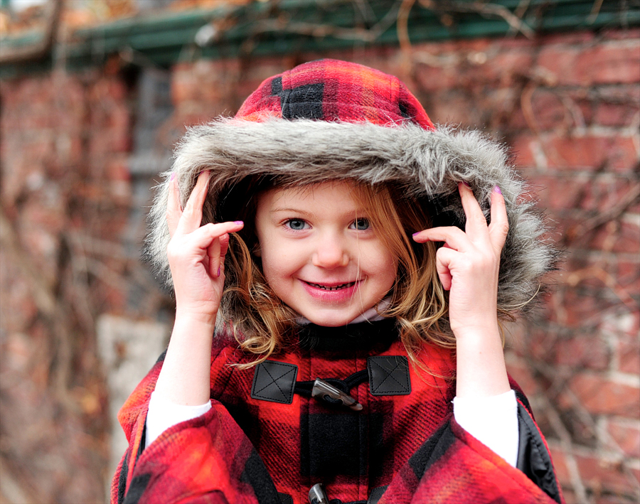 girl in red furry hood in winter