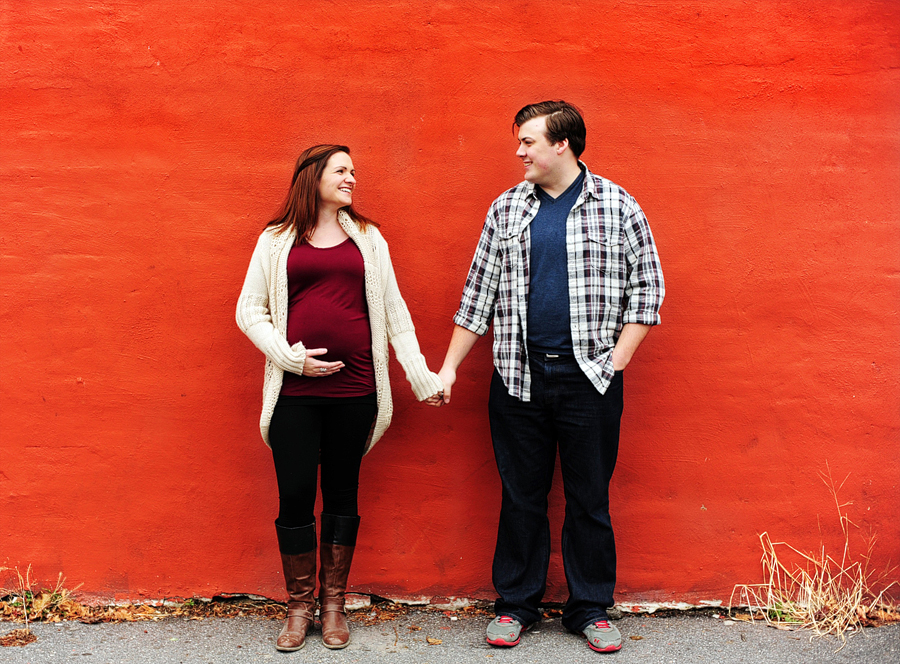 couple in front of red wall