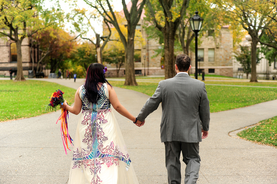 couple walking along brown campus