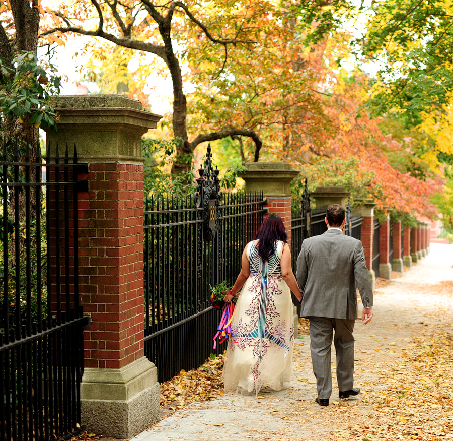 couple walking in autumn leaves