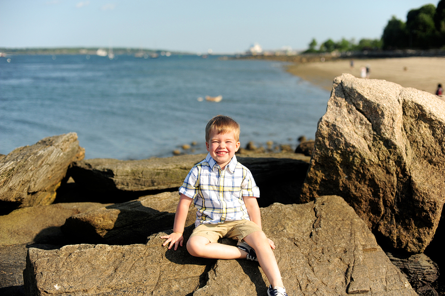 kid happily grinning at beach
