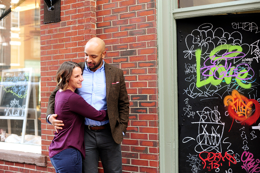 couple in front of brick wall