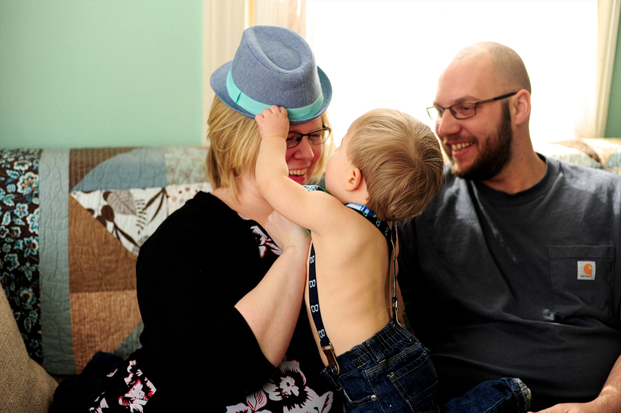 baby putting hat on mom