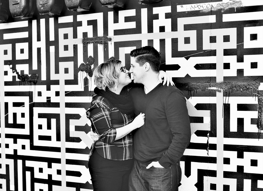 couple in front of geometric wall