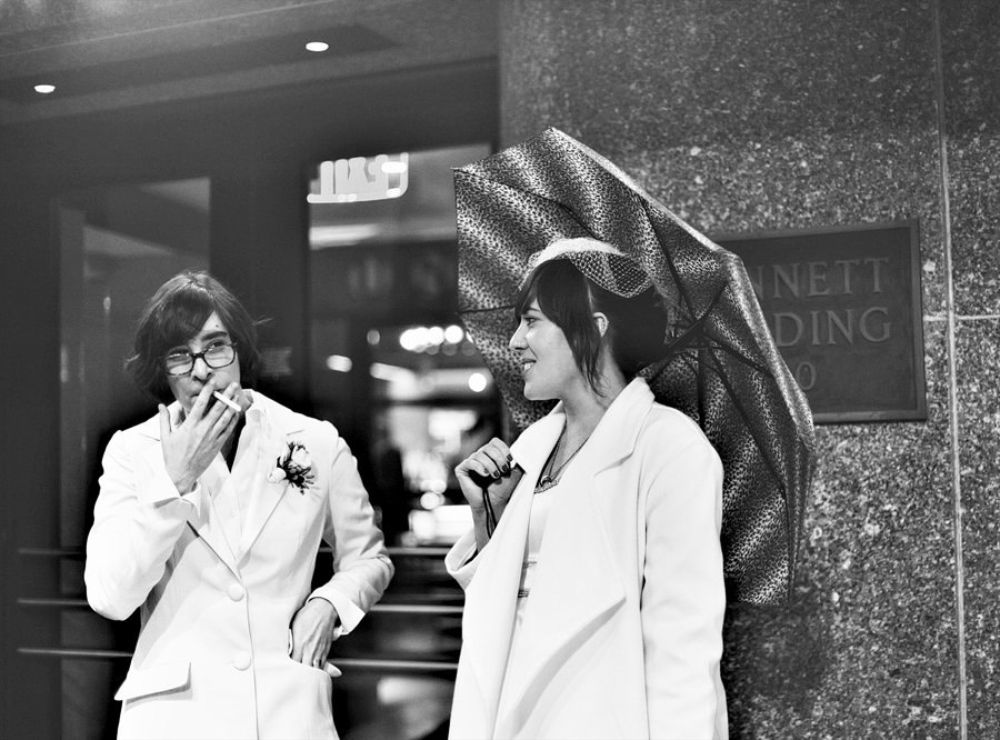 couple smoking under umbrella