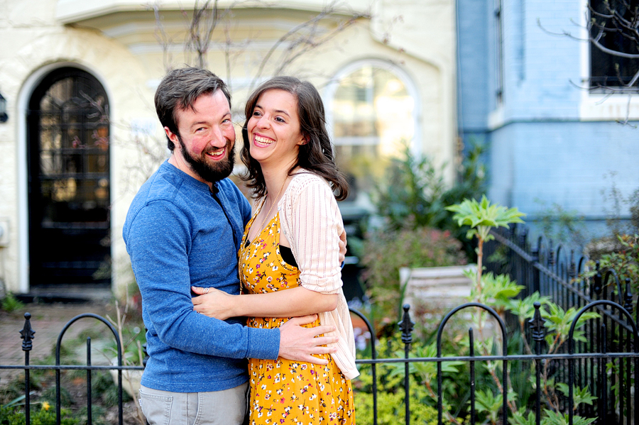 happy couple by wrought iron fence