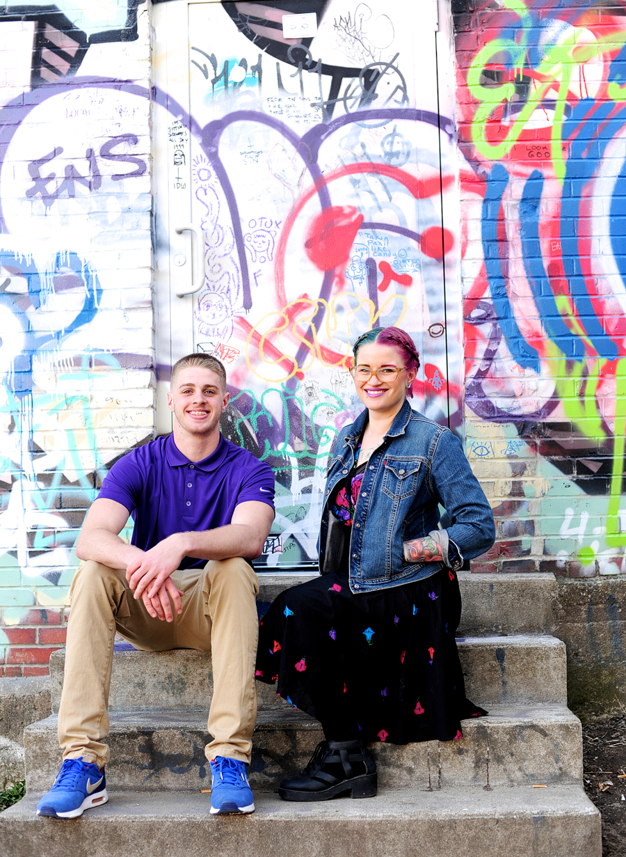 siblings in front of graffiti