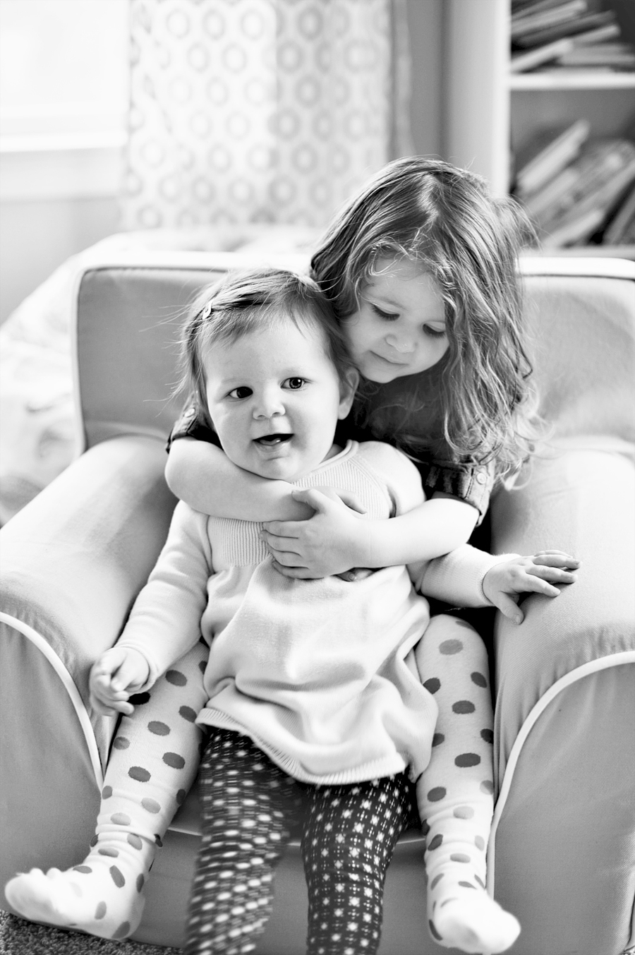 girl hugging her baby sister