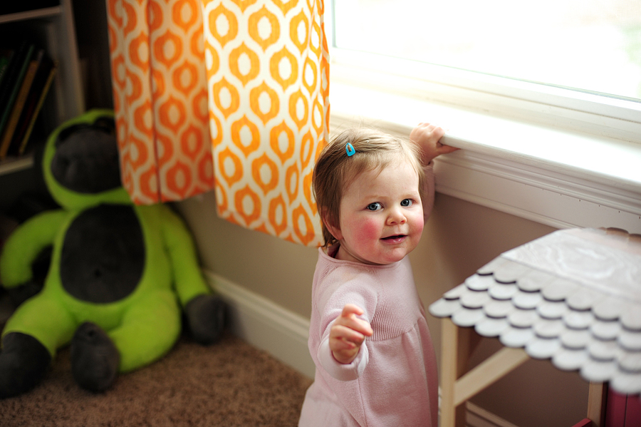 baby standing at window