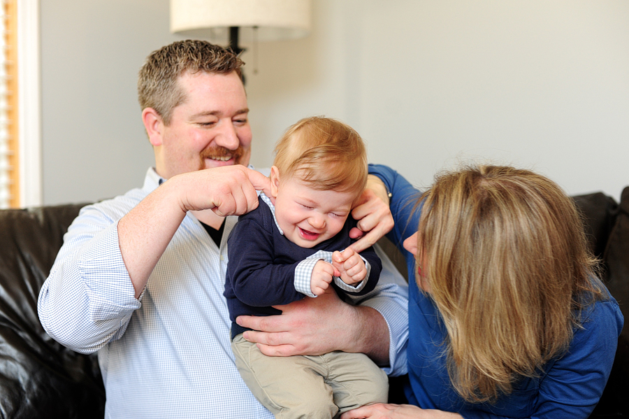 parents tickling baby