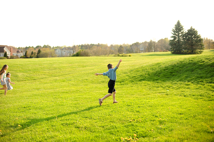 boy running in the grass