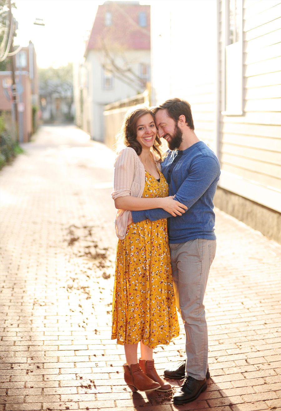 couple snuggling in alley