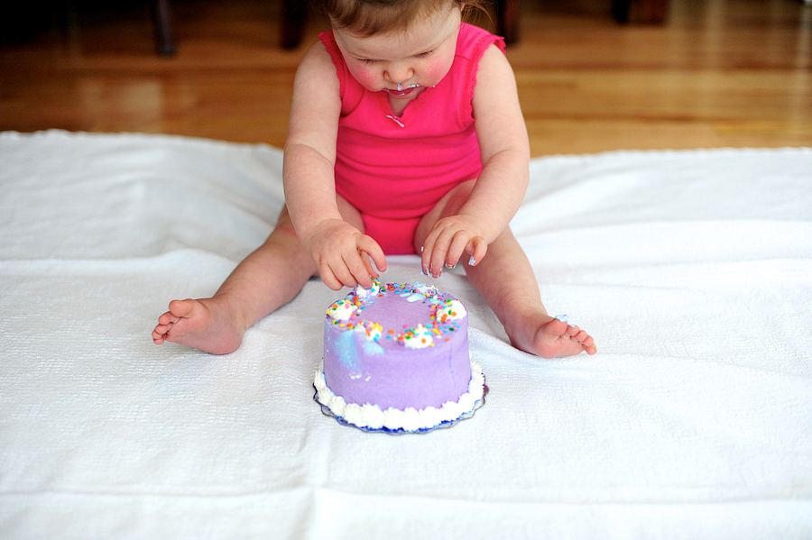 baby playing with cake