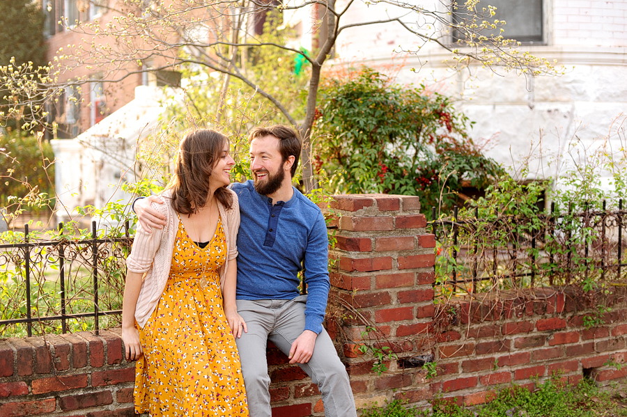 couple sitting on brick wall