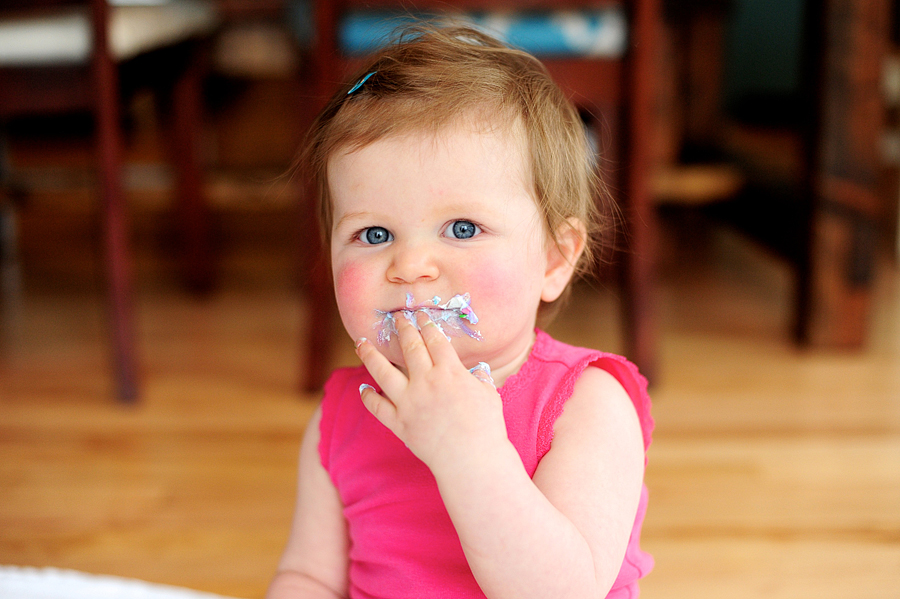 baby with frosting on her mouth