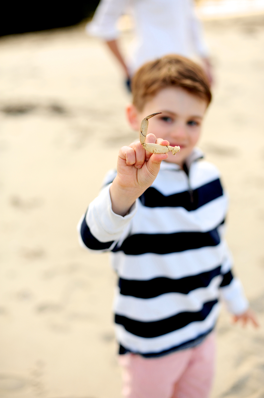 boy in striped shirt at beach