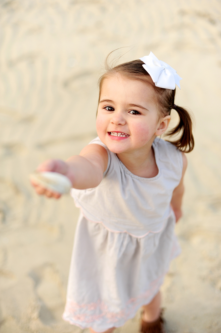 little girl showing shell 