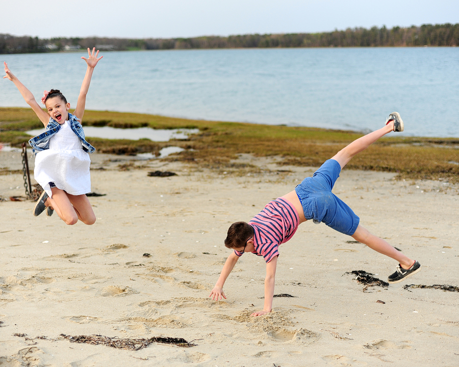 kids doing cartwheels on the beach