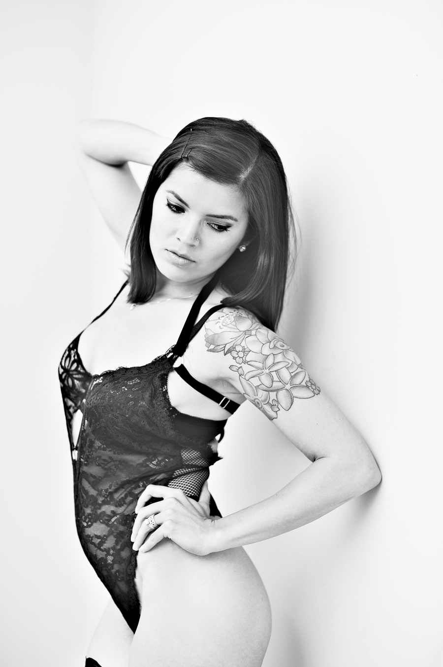 black and white boudoir photo of woman with tattoo