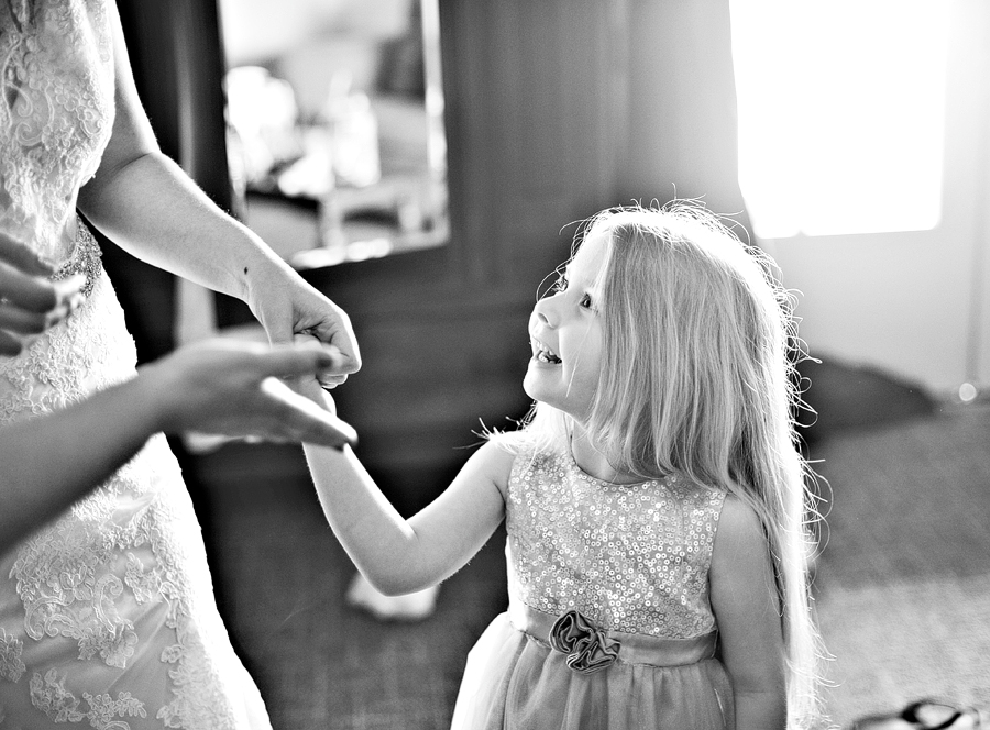 a young girl holding hands with her mom