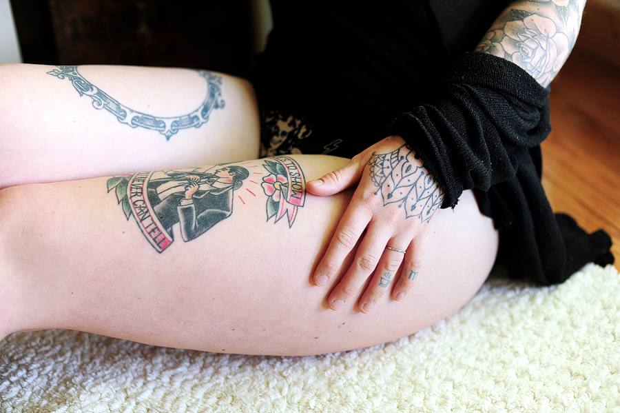 tattooed hand and thigh
