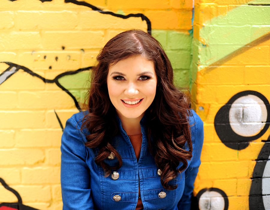 woman in front of yellow graffiti