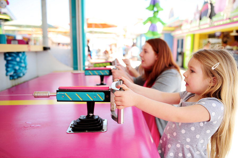 mother and daughter playing a boardwalk game