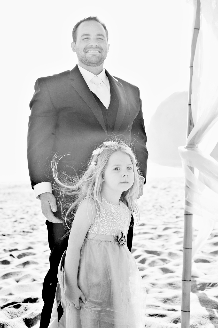 groom and the flower girl watching the bride