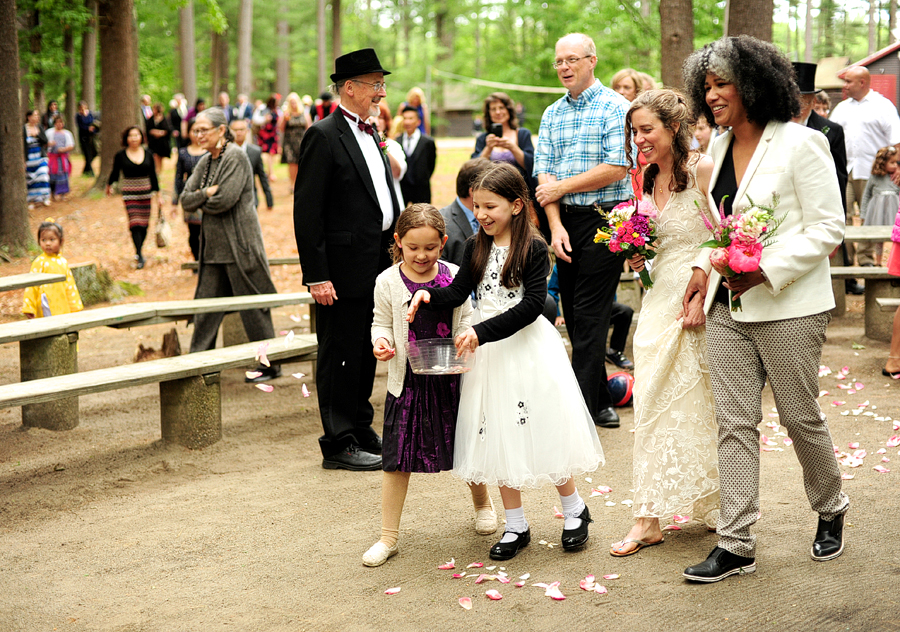 flower girls leading brides to outdoor ceremony