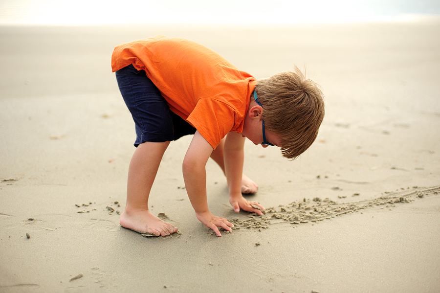 kid playing in the sand