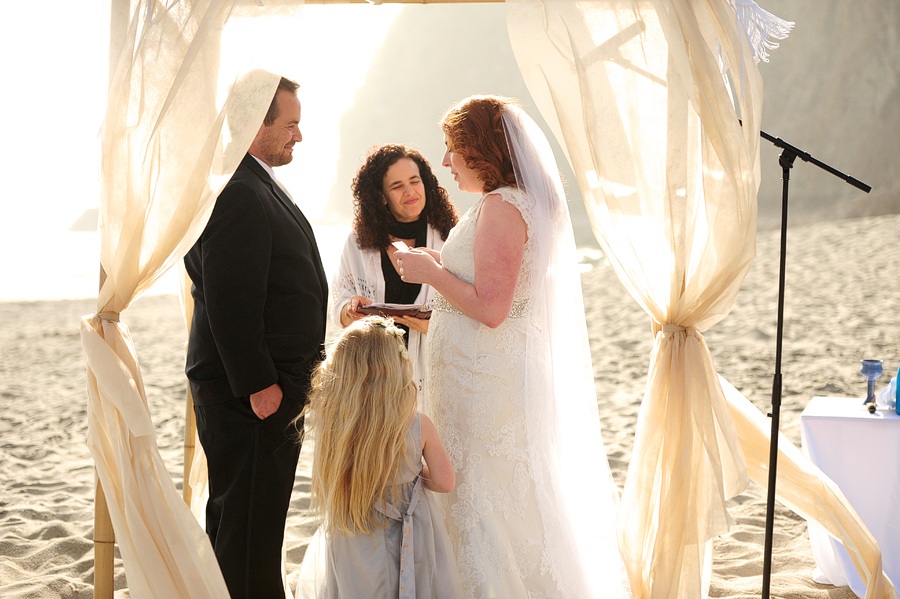 a bride reading her vows under a chuppah