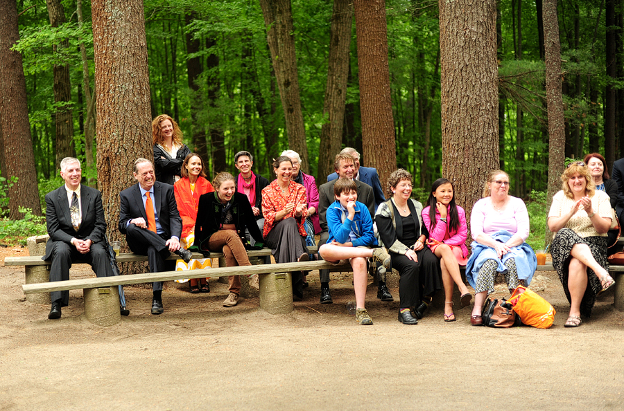 wedding guests sitting on benches