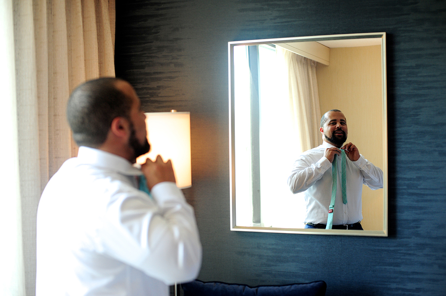 groom getting ready in the mirror