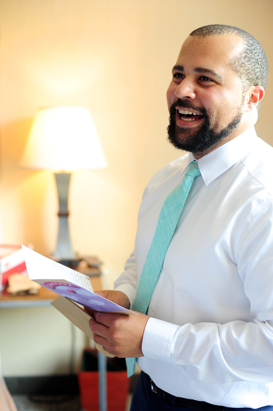 groom reading a card from his bride