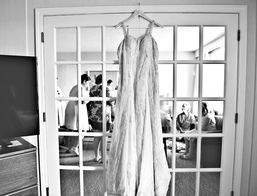 bride's dress hanging on french doors