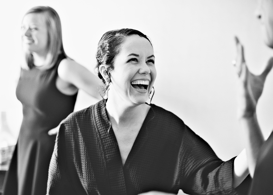 bride laughing while she gets ready