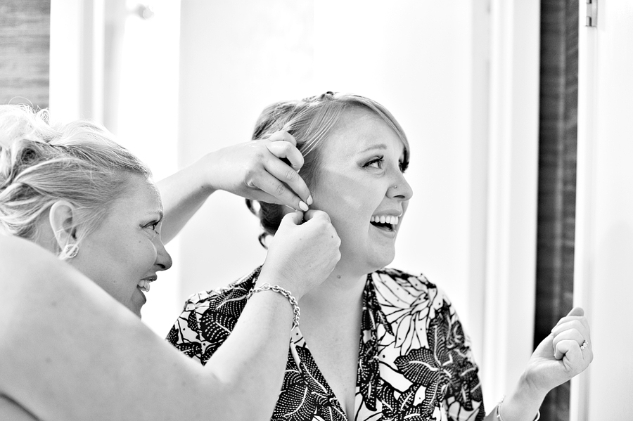 bride getting help while she gets ready