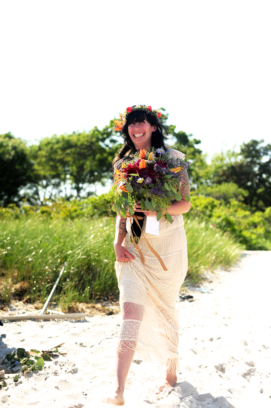 tattooed bride with a flower crown on the beach in maine