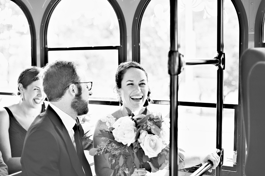 happy wedding couple taking a trolley around portland, maine