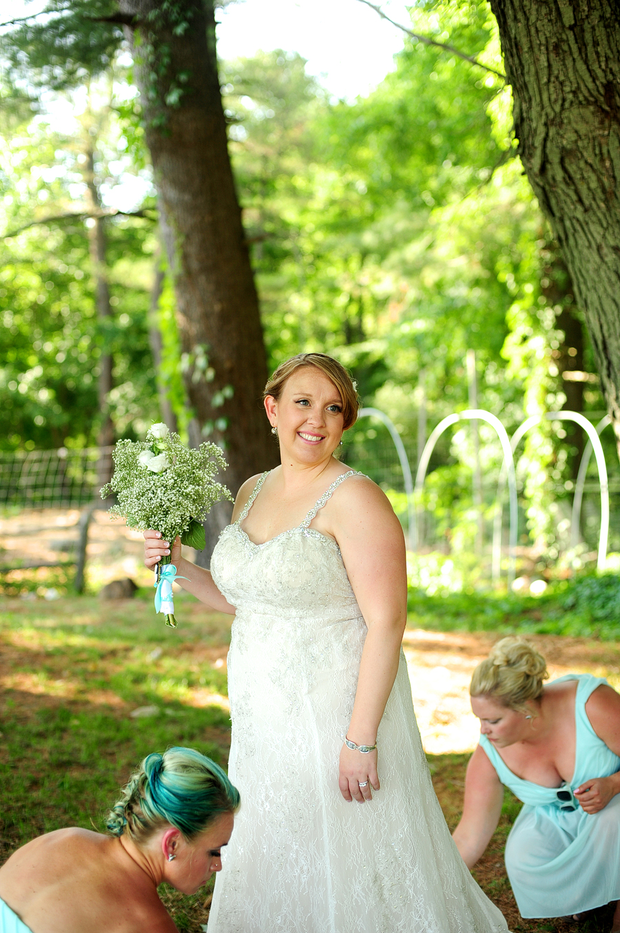 bride getting help with her dress