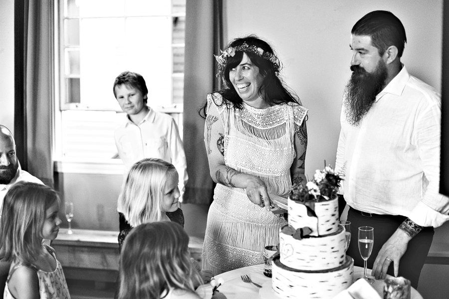 happy couple cutting their wedding cake in maine