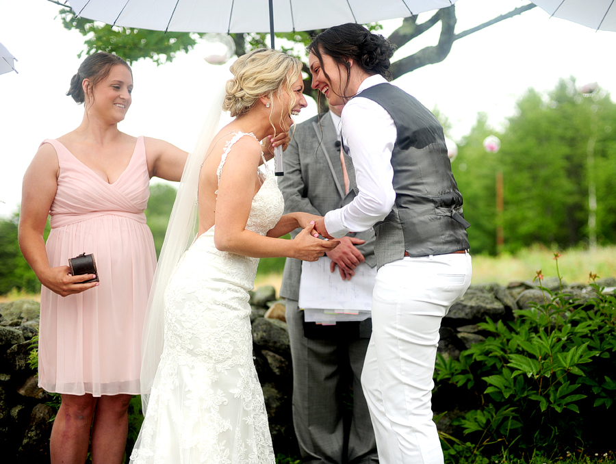 couple laughing in the rain at their wedding